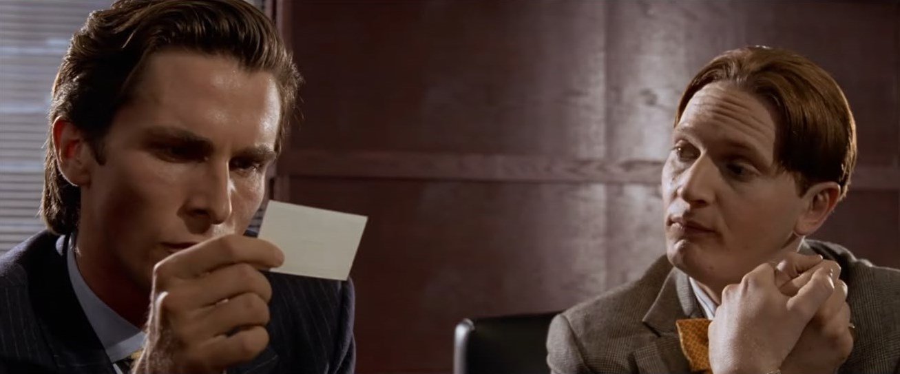 Patrick Bateman inspecting a business card — American Psycho